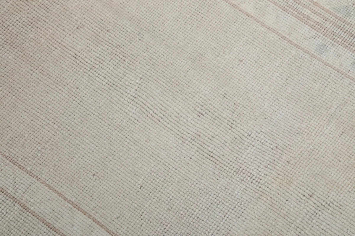 Close-up of the rug's low wool pile texture and subtle color variations.