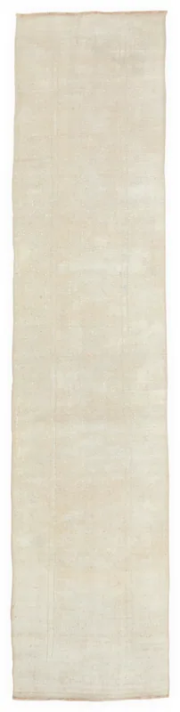 Full top view of the minimalist ivory Anatolian runner rug on a white background.