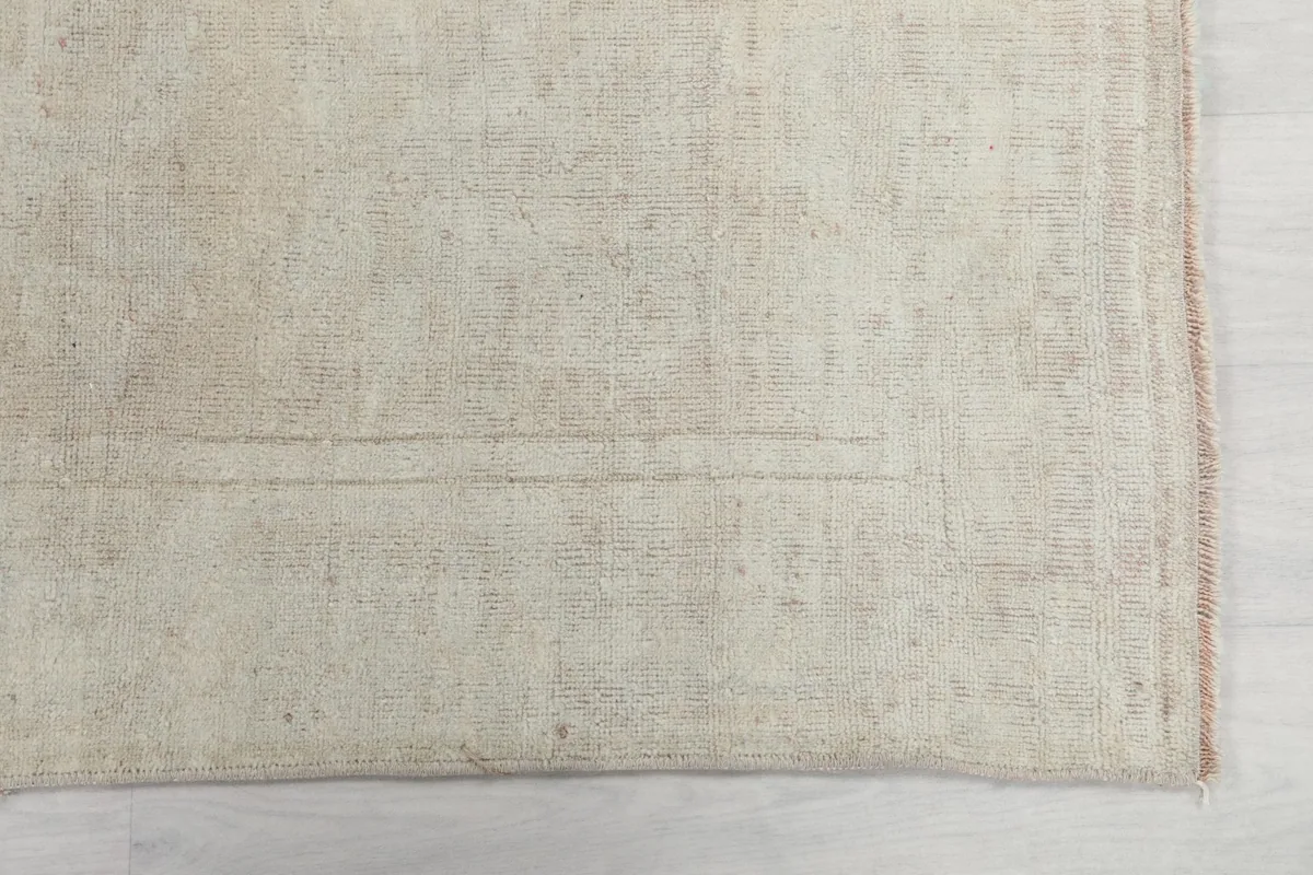 Detailed view of the rug's surface, highlighting the subtle color variations and low pile.
