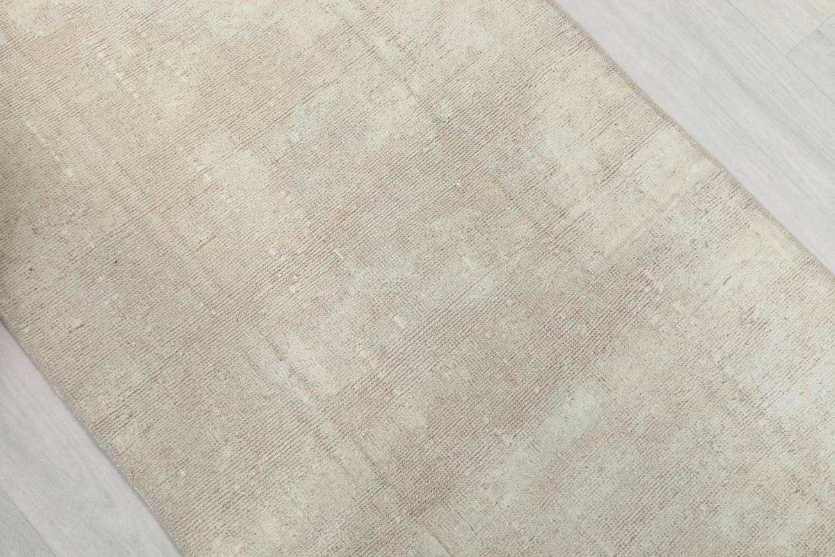 Overhead view of a section of the ivory runner, showing its distressed texture.