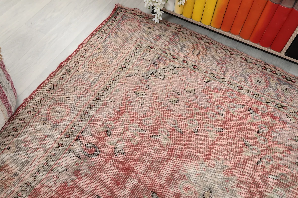 Diagonal view of the rug highlighting the faded color variations and border design