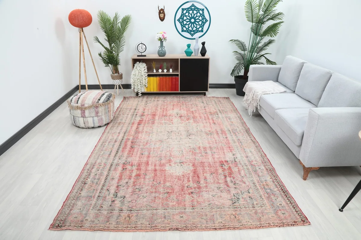 Vintage Anatolian rug displayed in a living room setting with a gray sofa
