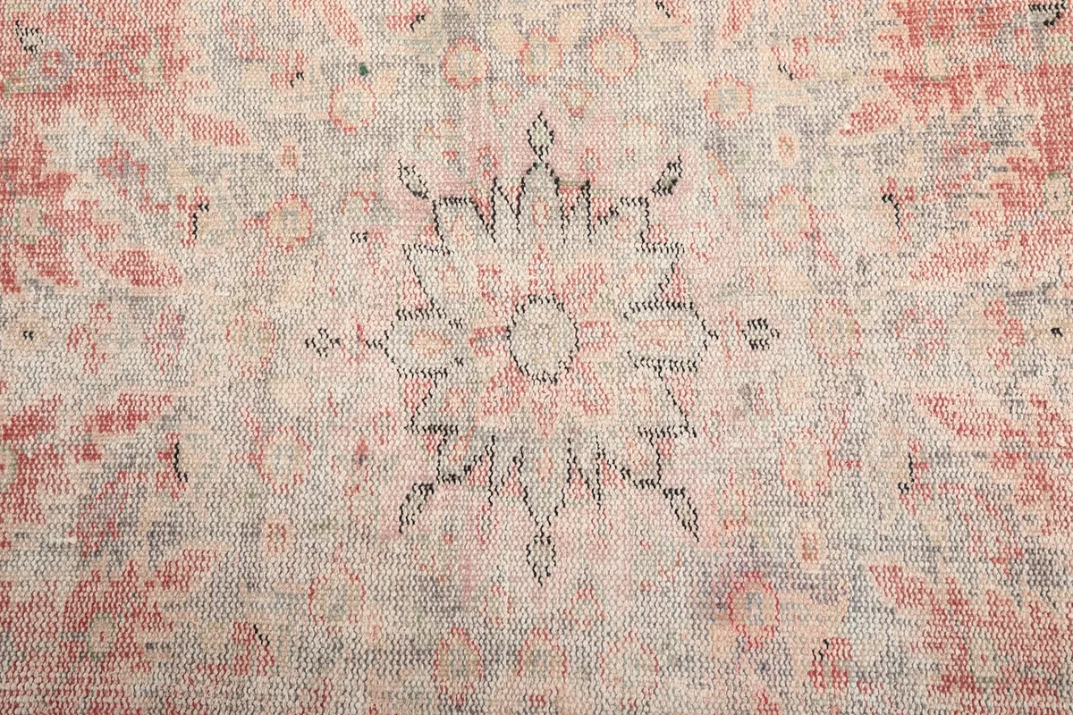 Close-up of the faded medallion motif with gray outlining