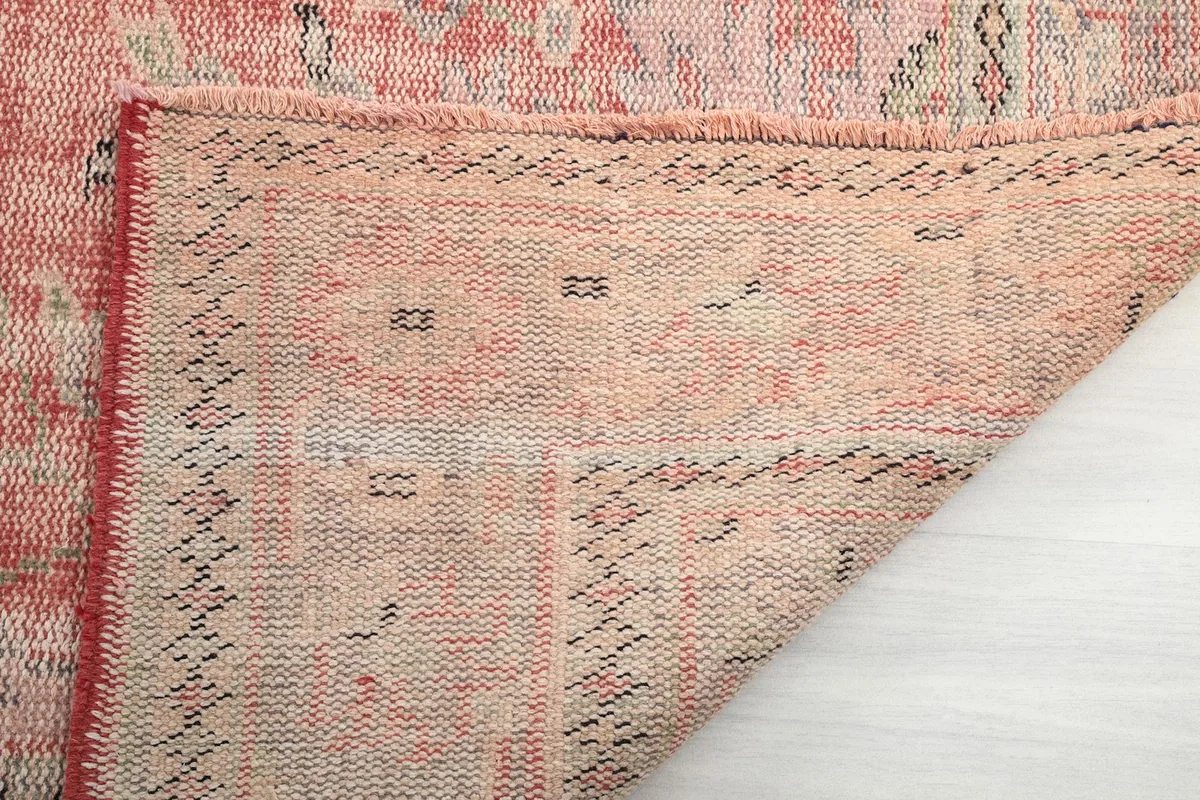 Close-up of the rug's reverse side, showing the hand-knotted cotton foundation
