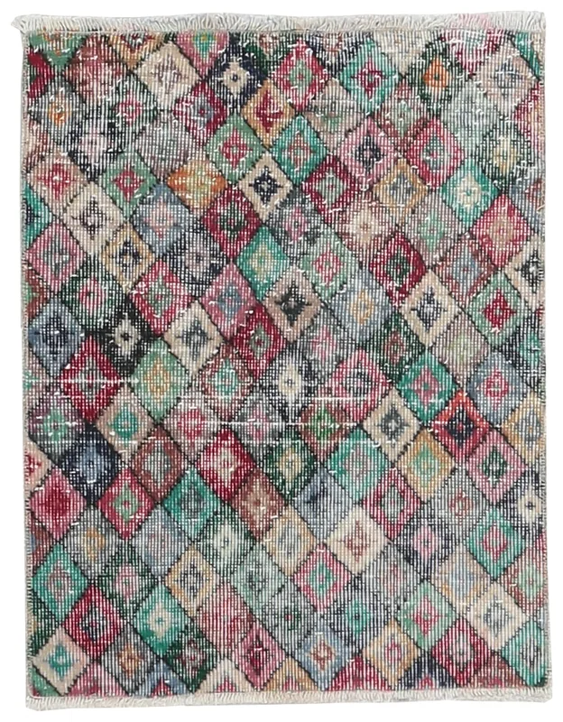 Full top view of the multicolor geometric diamond vintage Anatolian rug on a white background