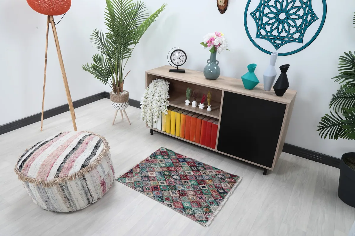 Overhead view of the multicolor geometric rug in a room setting, showing its scale