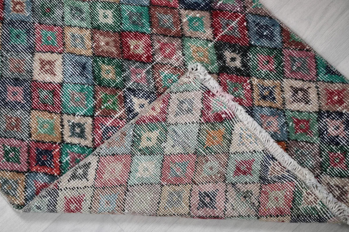 View of the back of the hand-knotted rug, revealing the cotton foundation and construction
