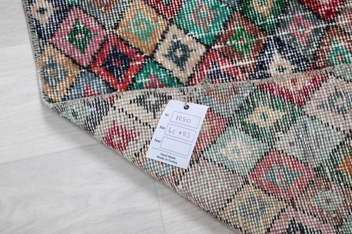 View of the rug with a product tag, indicating its dimensions and origin