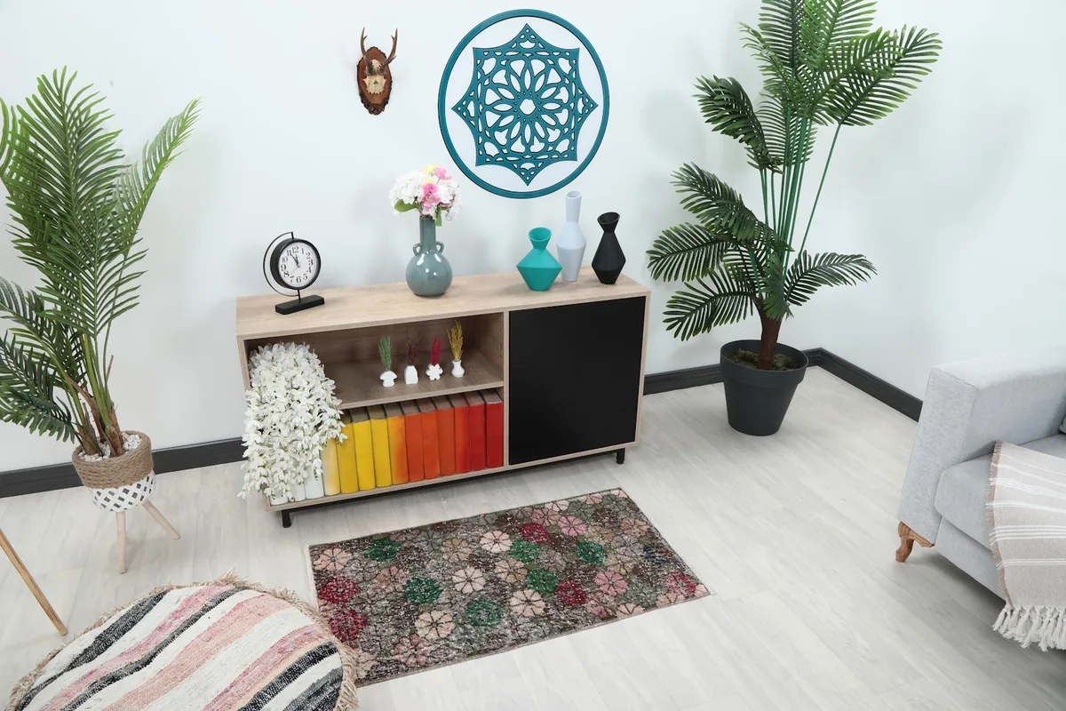 Angle view of the multicolor rug in a room setting with a chair and console