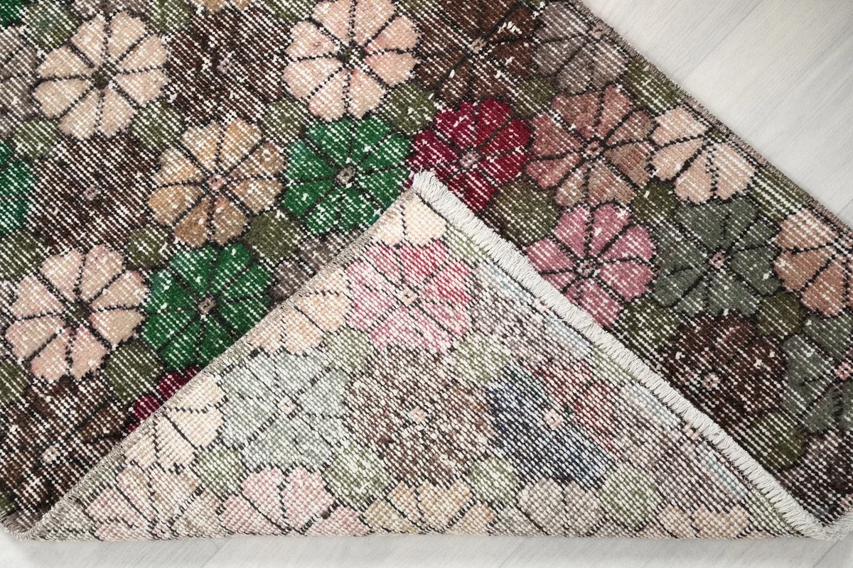 Folded corner showing the reverse side of the hand-knotted rug and its foundation