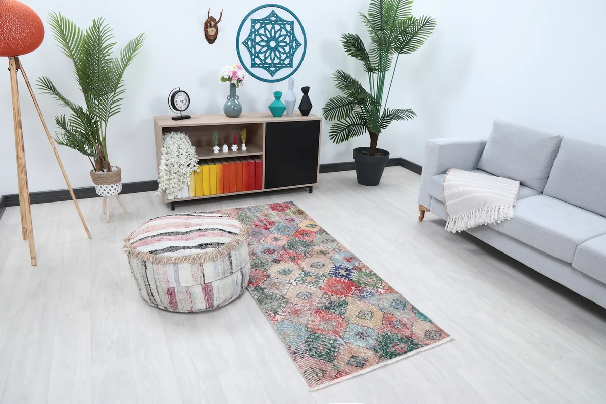 Angle view of the vibrant patchwork runner rug in a room setting, showing its length and colors