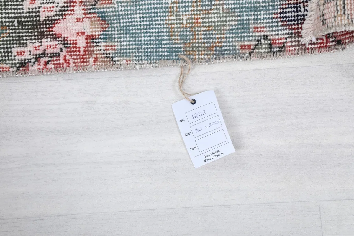 Rug tag displaying details like size 80 x 200 cm, material, and origin: Hand Made in Turkey