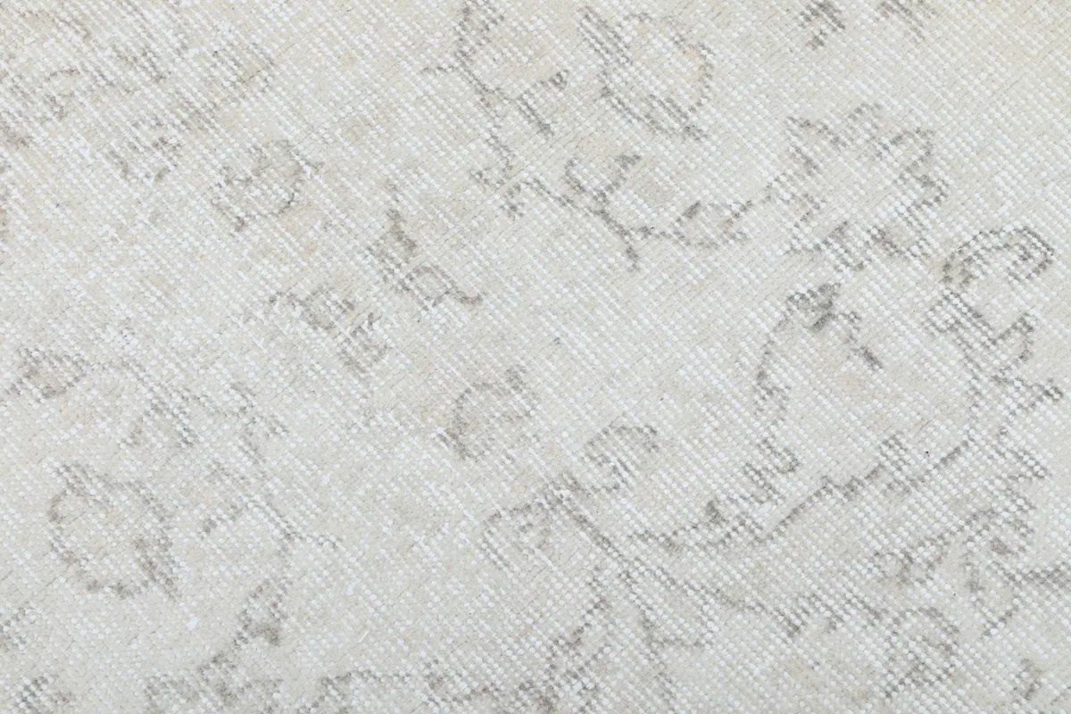 Close-up of the low wool pile and the intricate, faded hand-knotted patterns