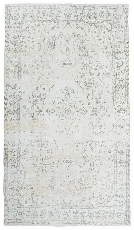 Full top view of a large vintage ivory and charcoal floral medallion rug on a white background.