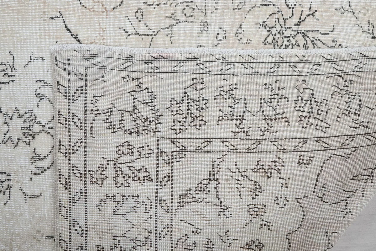 Close-up of the back of the rug where it is folded, showing the hand-knotted construction.