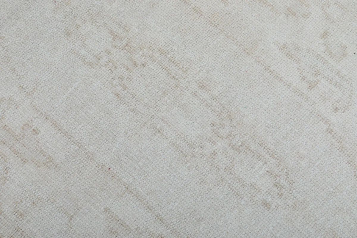 Texture shot of the low wool pile, showing the subtle color variations and wear