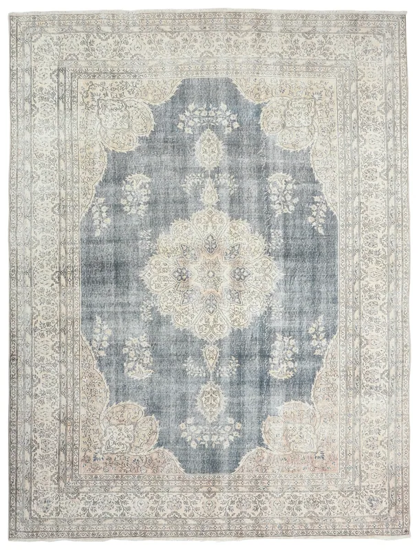 Full overhead view of the blue and ivory vintage Anatolian rug with a central medallion on a white background.