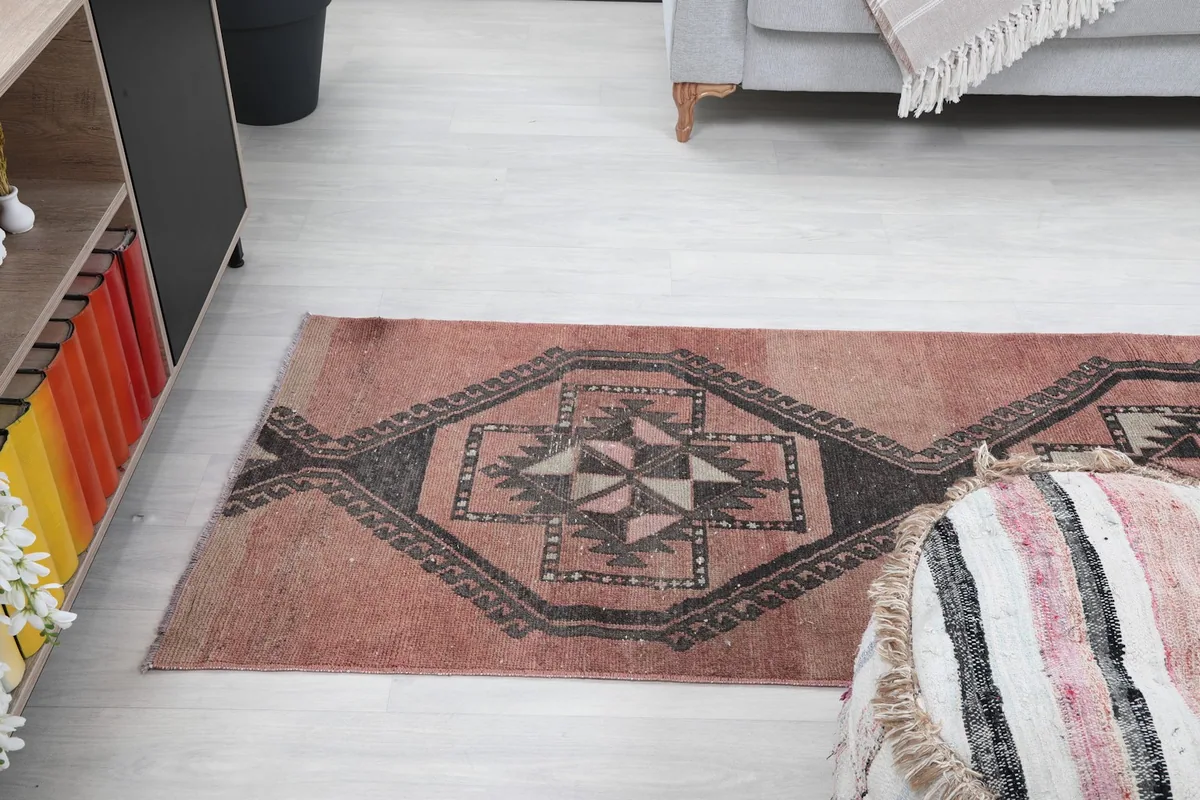 Angled view of the runner rug extending into a room, showing its length and pattern flow.
