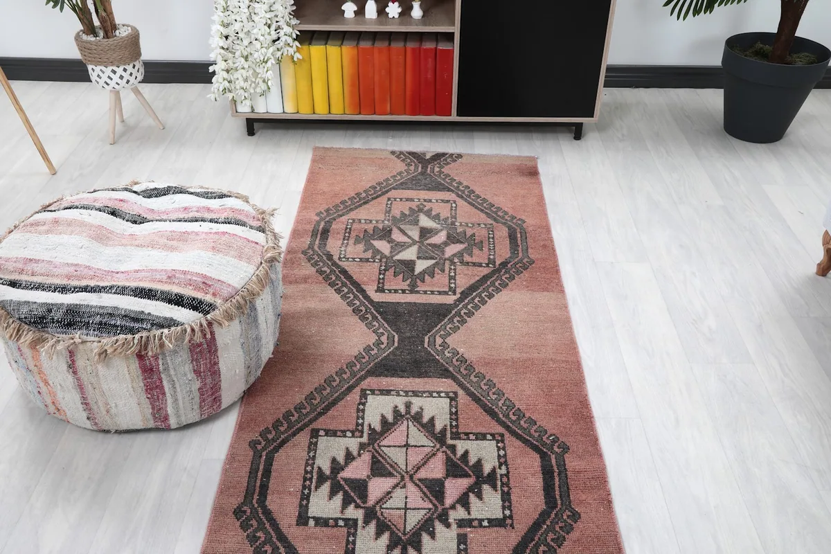 Overhead view of the runner rug in a room, with a pouf in the foreground.