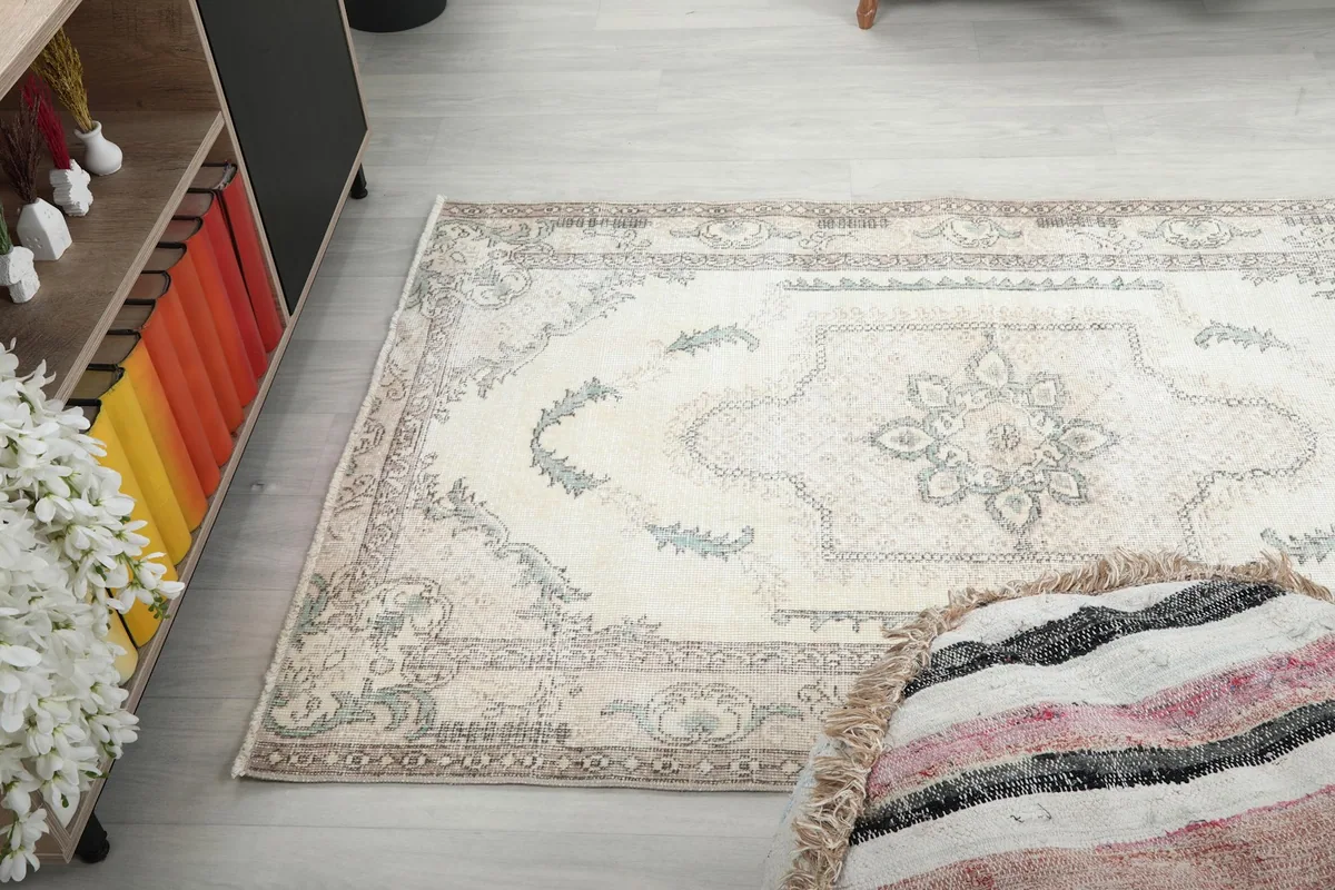 Angled view of the rug laid out, showing its full design and colors