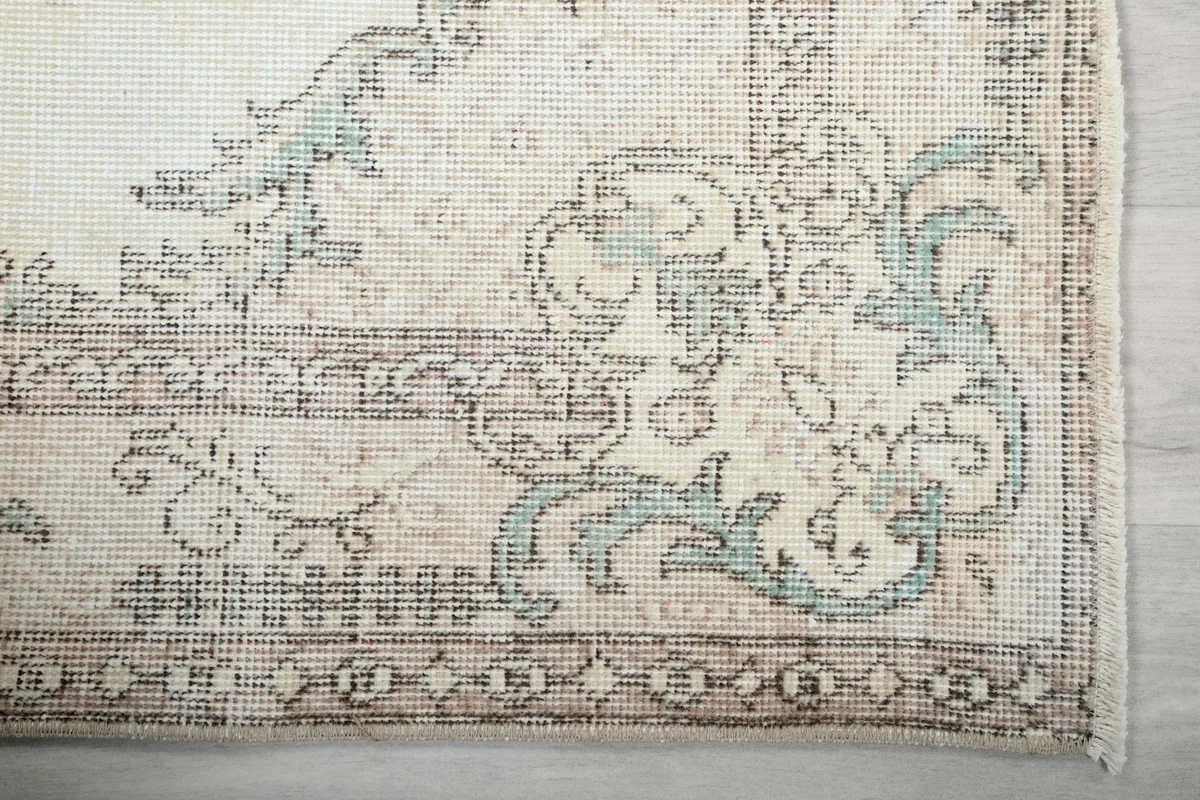 Corner detail of the rug showing floral patterns and border
