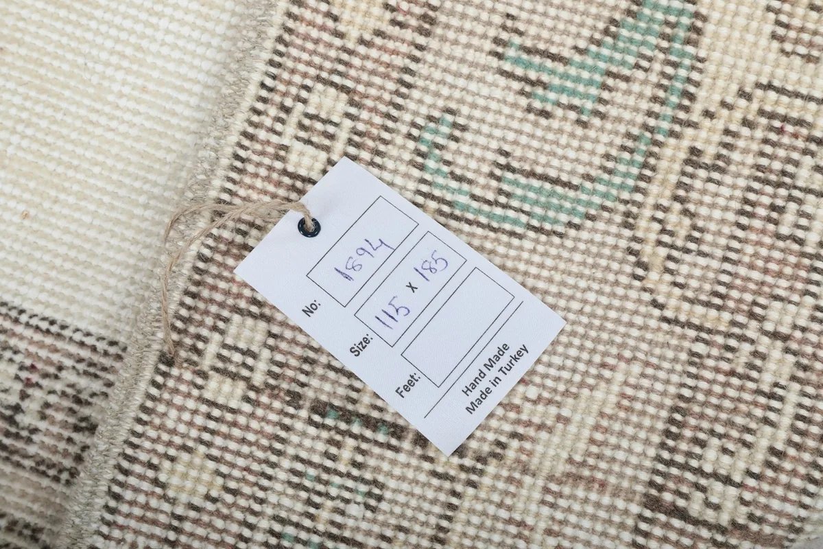 Back of the rug showing hand-knotted construction and size tag