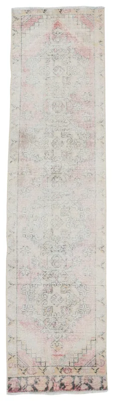 Full overhead view of the beige and rose geometric vintage runner rug