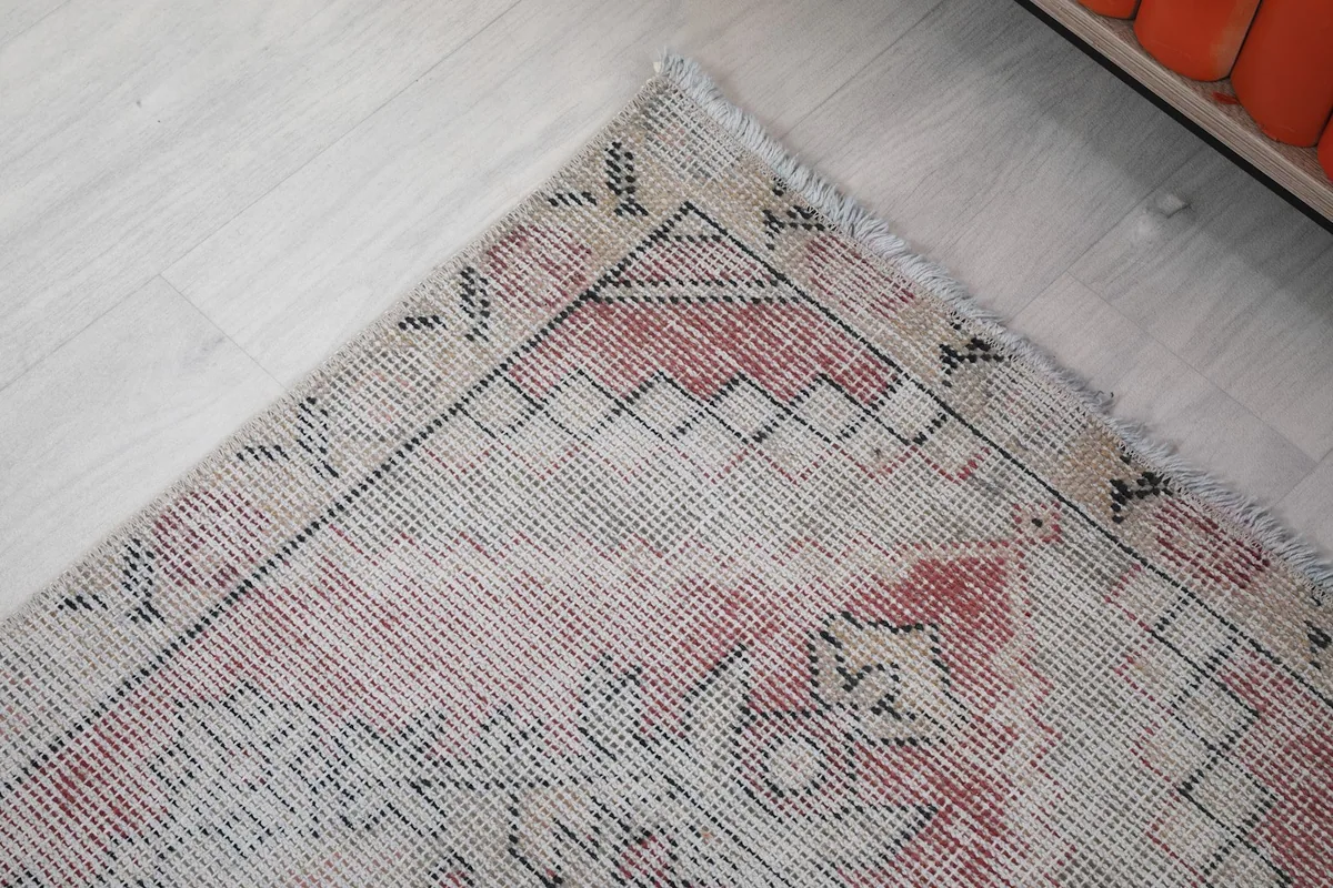 Corner detail of the rug, highlighting the geometric motifs and color blend