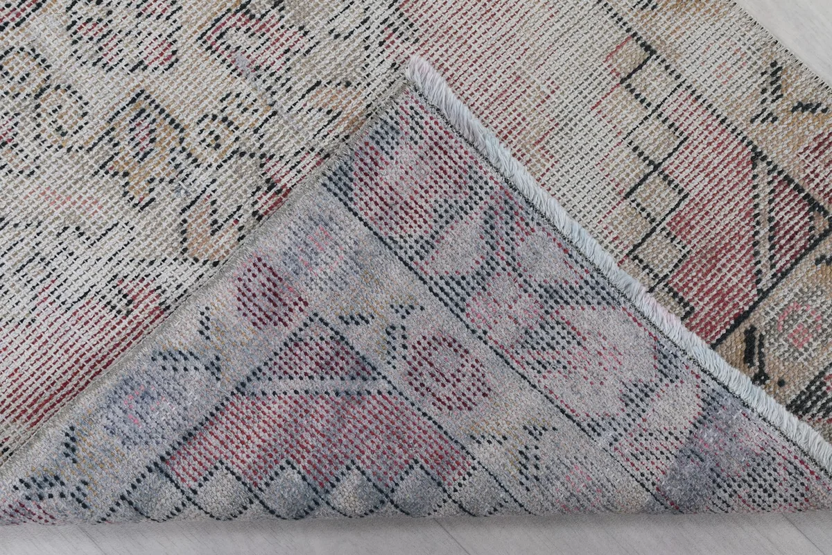 Underside of the hand-knotted rug, revealing the cotton foundation and knotting