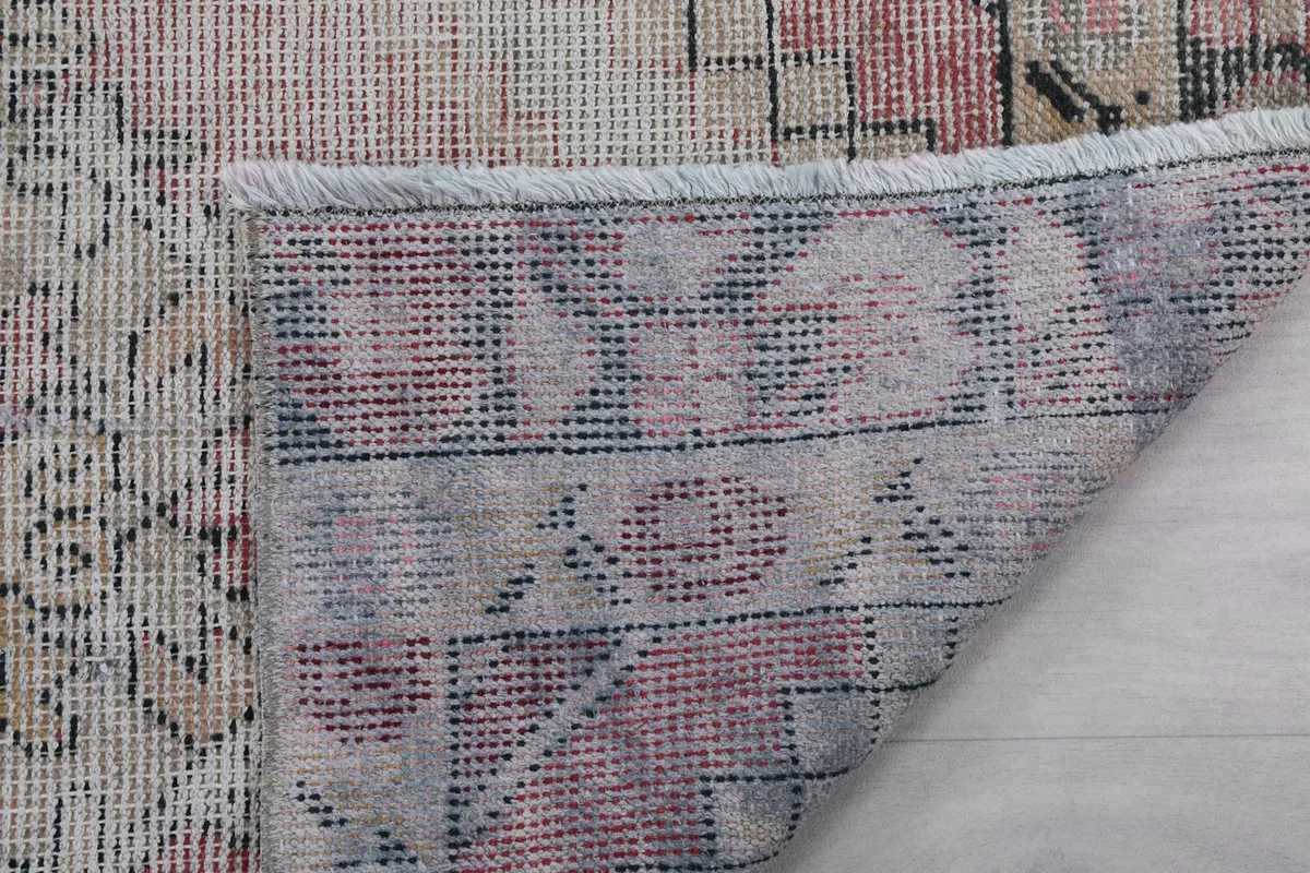 Close-up of the rug's back, showing the consistent hand-knotting and fringe