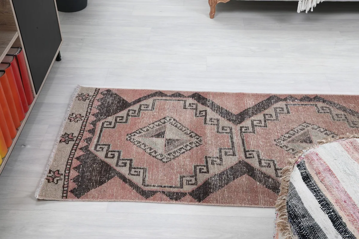 Angle view of the runner rug in a room, emphasizing its length and pattern flow.