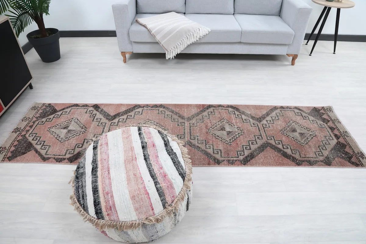 Wide shot of the vintage runner rug in a living room setup, showing its scale.