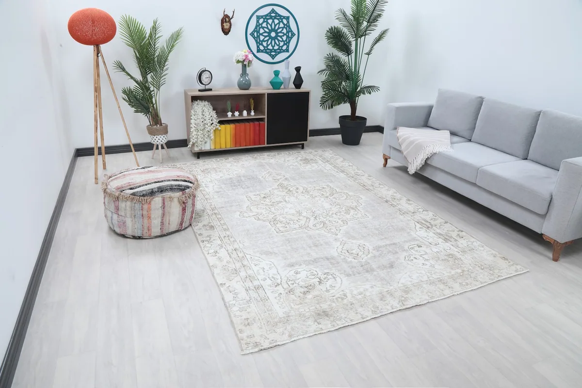 Wide shot of the gray medallion rug in a room, showing its scale relative to furniture