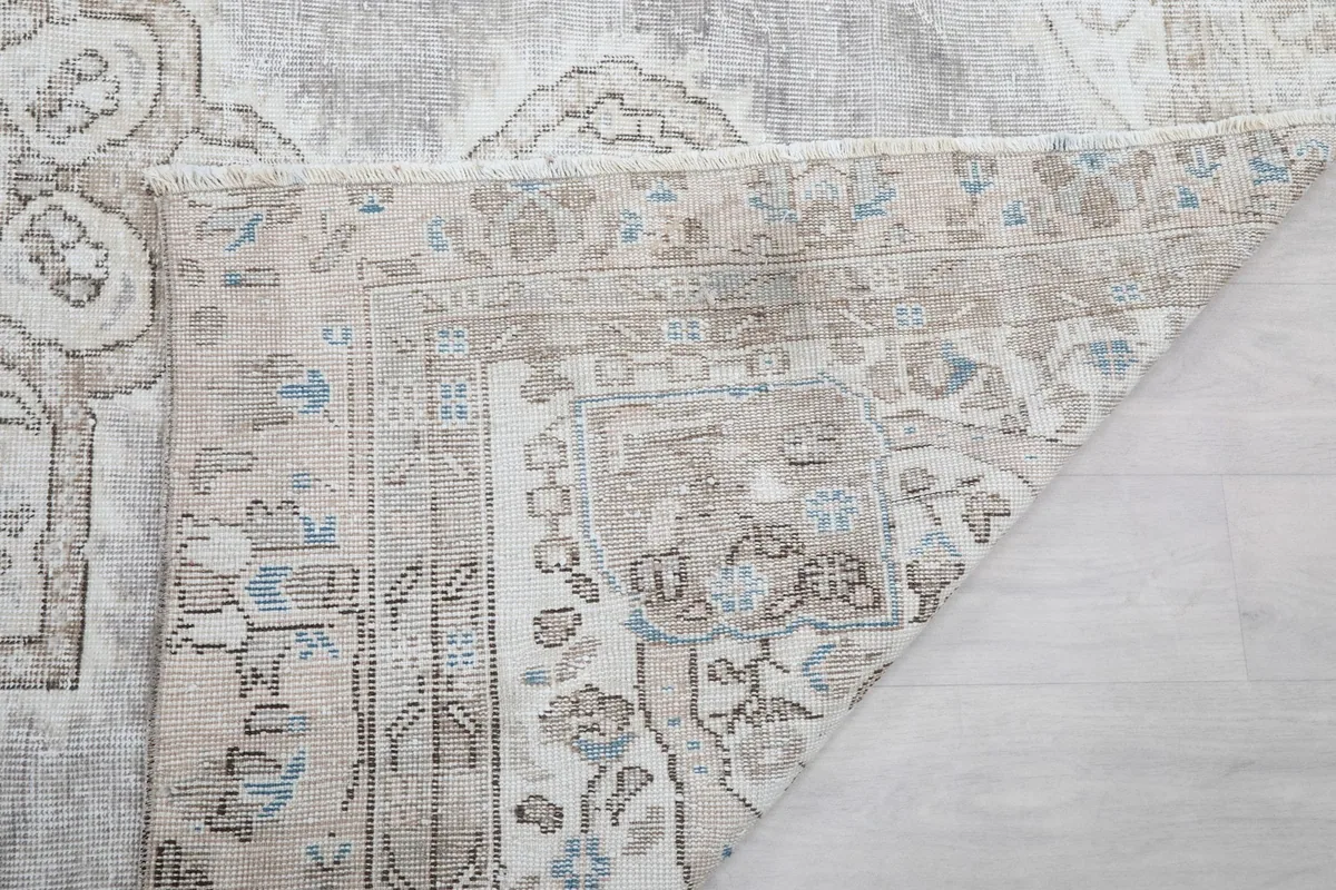 Close-up of the rug's back, revealing the hand-knotted construction and fringe