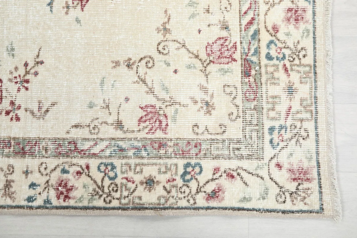 Detailed view of the rug's corner, showing the intricate floral and geometric border design
