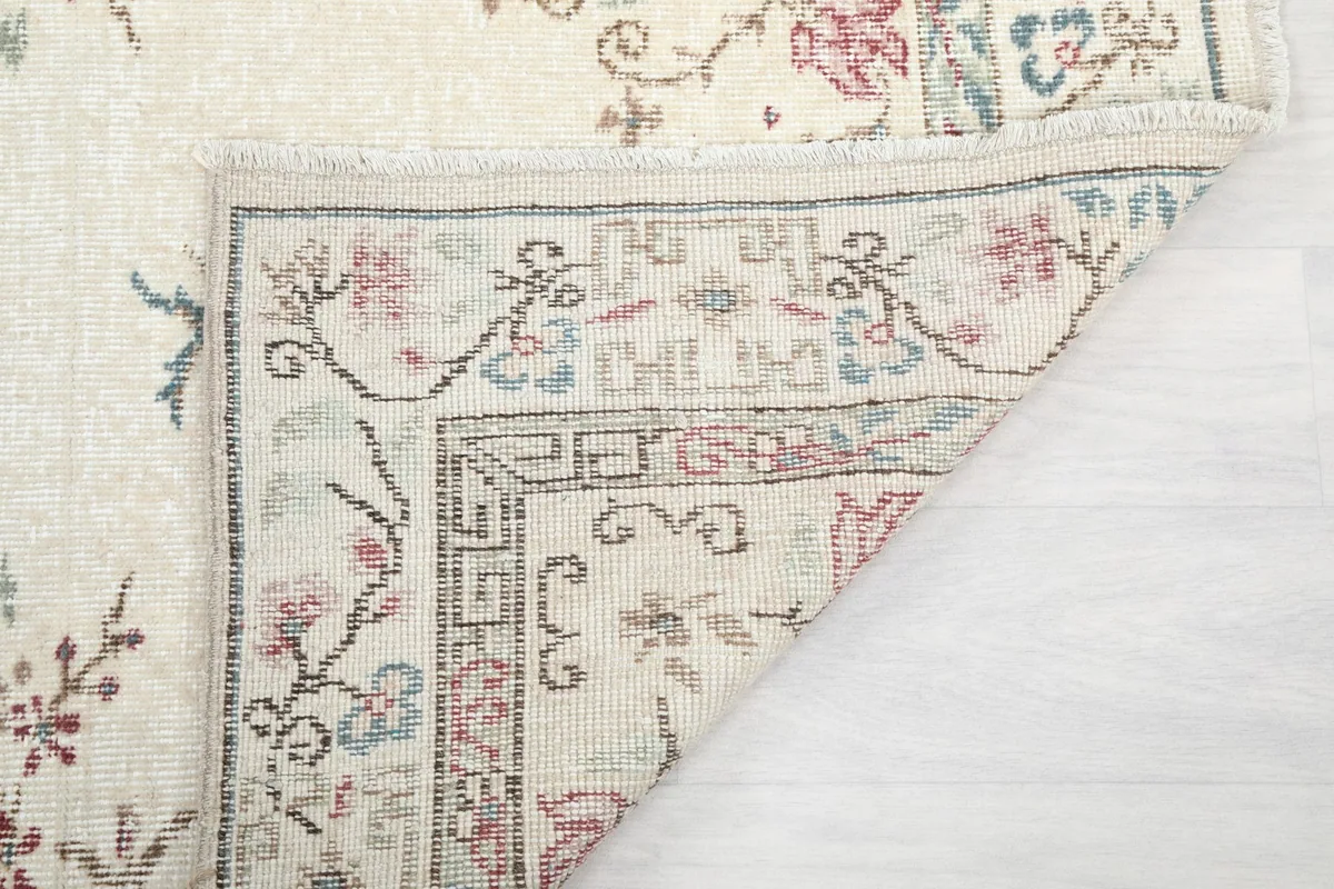 Another folded corner, highlighting the reverse side and the tight knotting of the rug