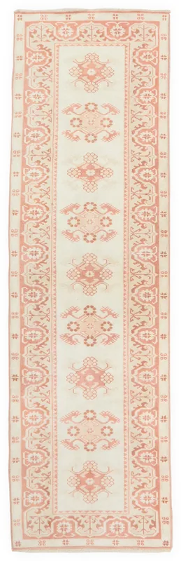 Full top view of the 2'7" x 10'2" vintage Anatolian runner rug with rose geometric patterns on an ivory field.