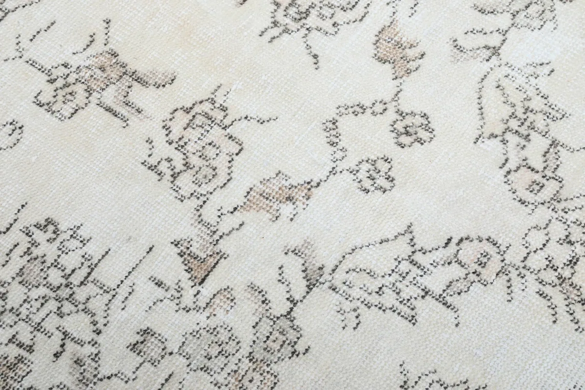 Extreme close-up showing the texture and subtle brown-tan tones in the floral patterns