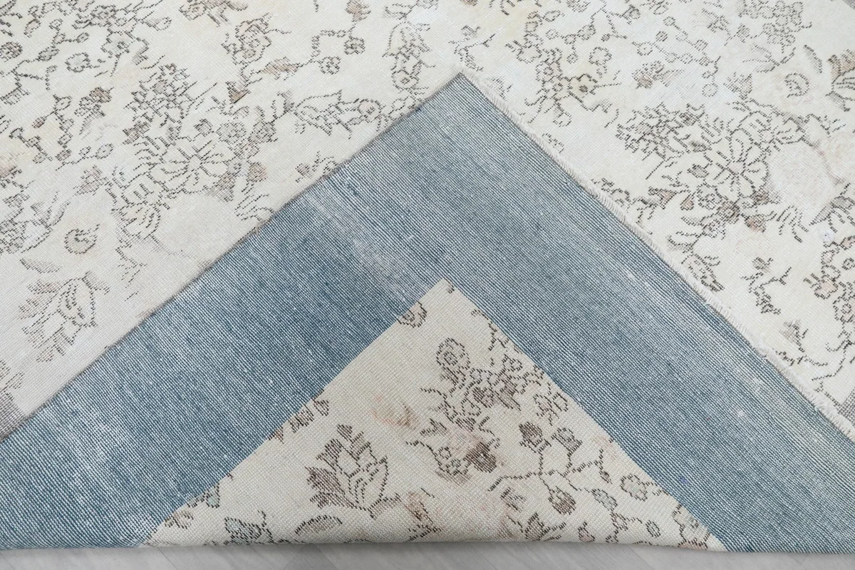 View of the reverse side of the rug, showing the cotton foundation and knotting