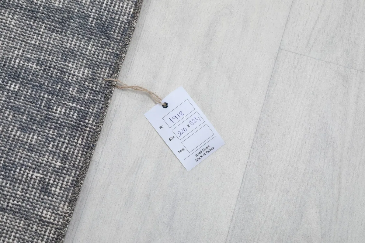 Product tag displaying the rug's size and origin, next to the rug's edge