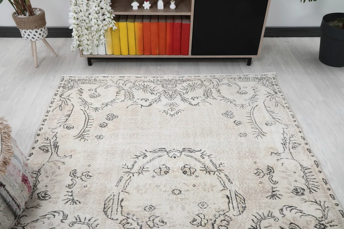 View of the rug in a room, focusing on the upper half and its decorative border