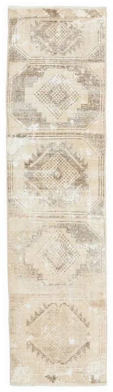 Full overhead view of the tan and brown geometric tribal runner rug