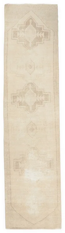 Full overhead view of the 2'11" x 12'2" ivory and tan geometric vintage runner rug on a white background.