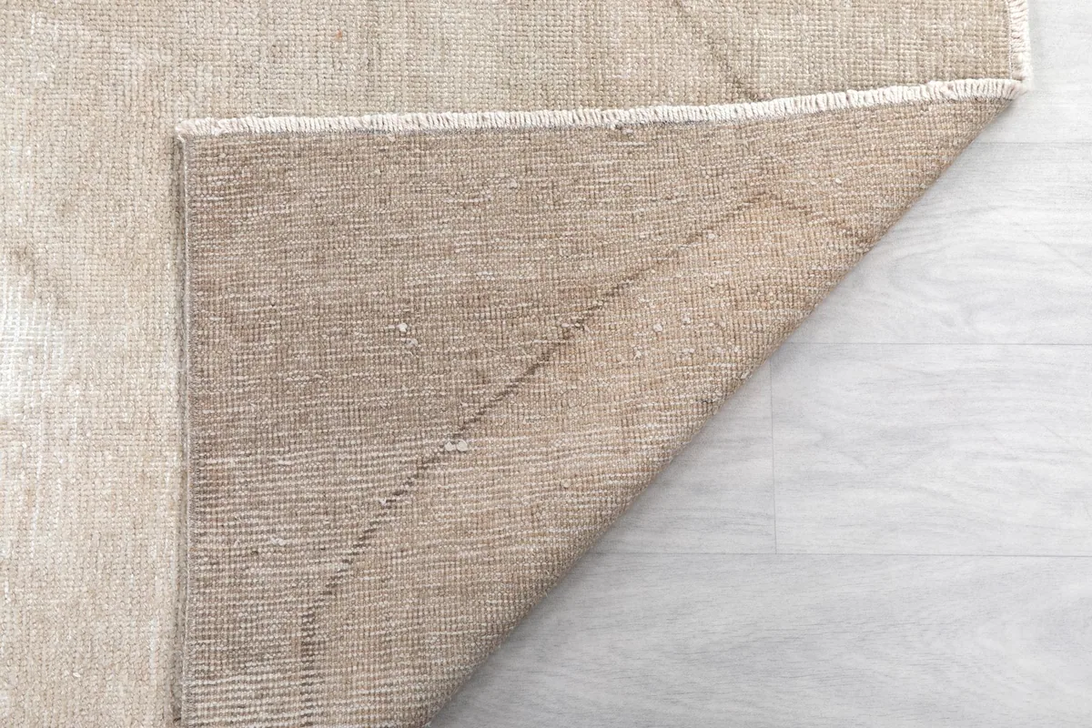 Another view of the rug's underside, showing the sturdy cotton foundation and craftsmanship.