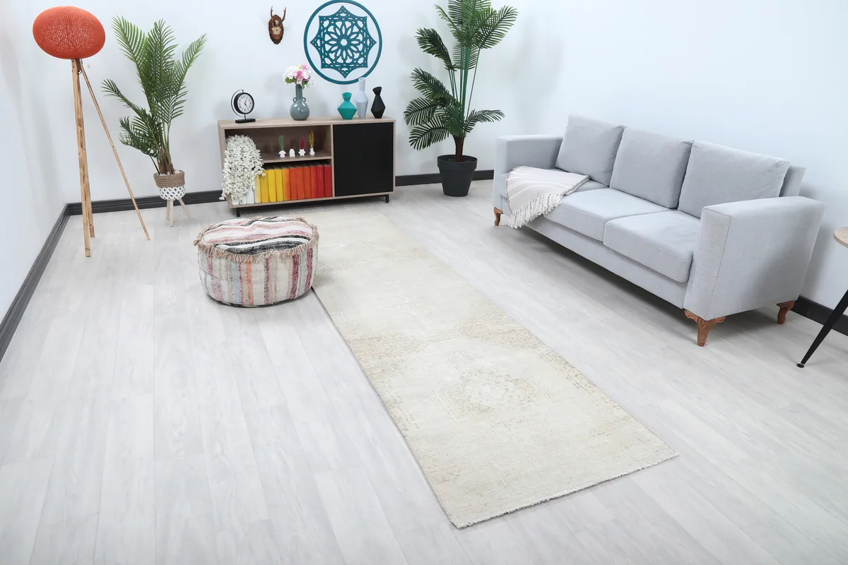 Beige Faded Geometric Anatolian Runner in a bright room with a sofa and pouf
