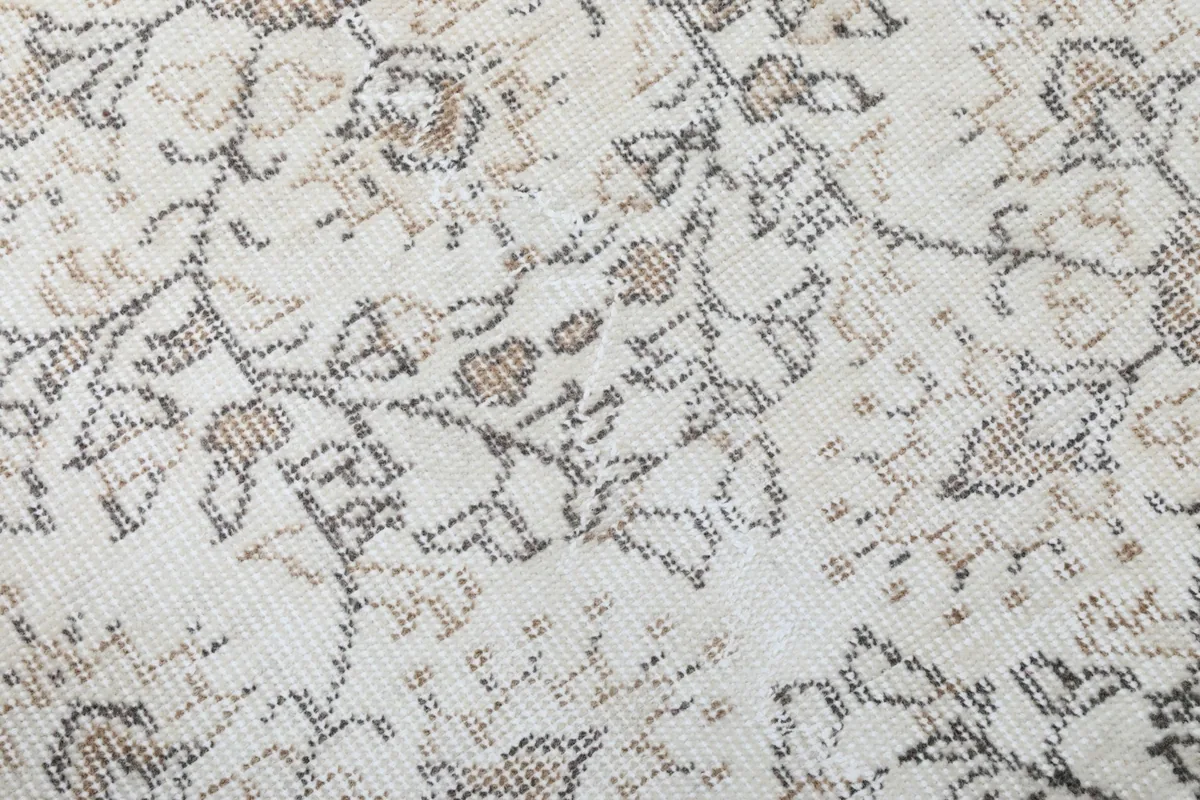 Close-up of the intricate hand-knotted details and subtle color variations in the rug's pattern.