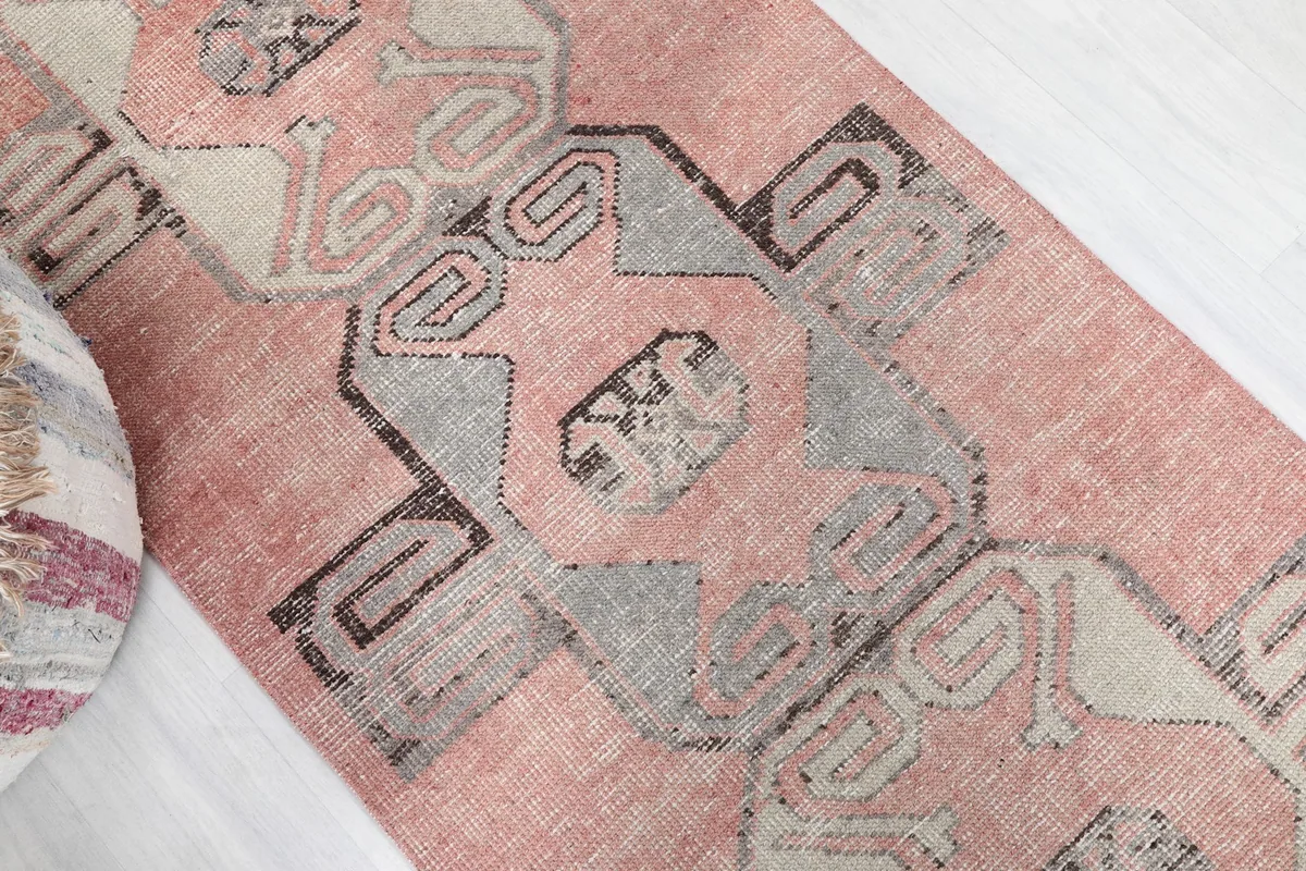 Overhead angle of the vintage rose runner rug's pattern and color variation