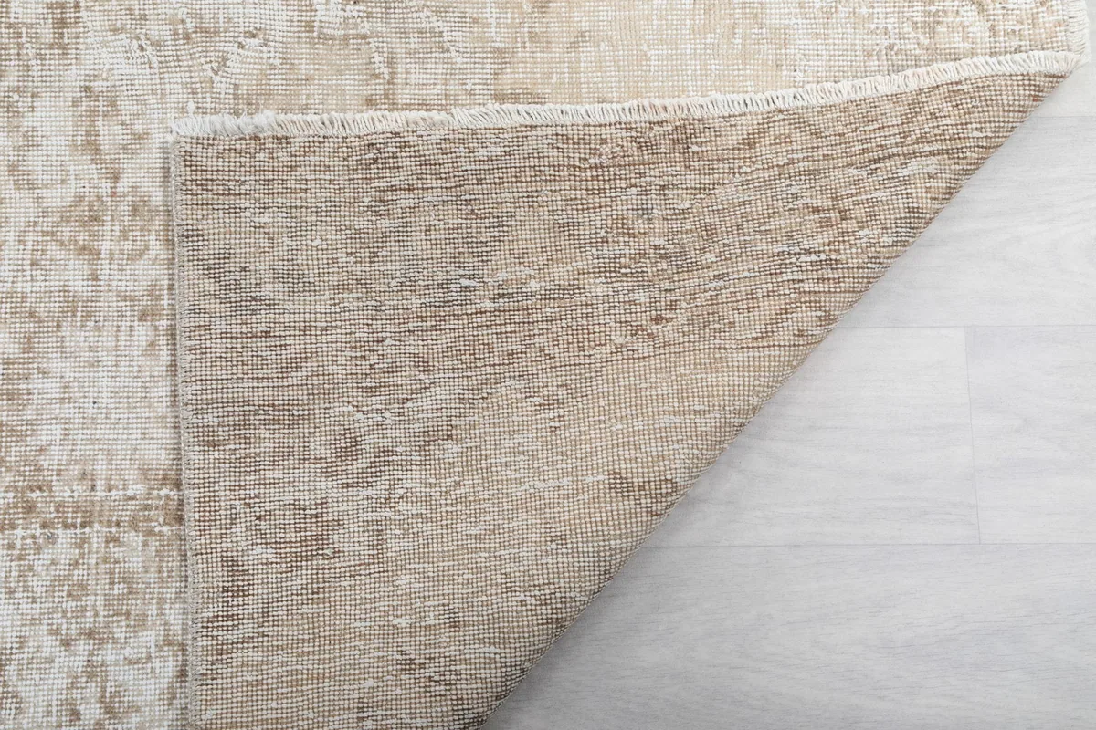 Corner view of the rug's back, revealing the tight knotting and material integrity.