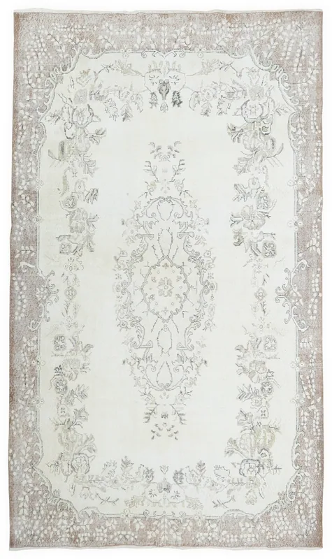 Full overhead view of the vintage Anatolian rug with a cream field and beige floral patterns