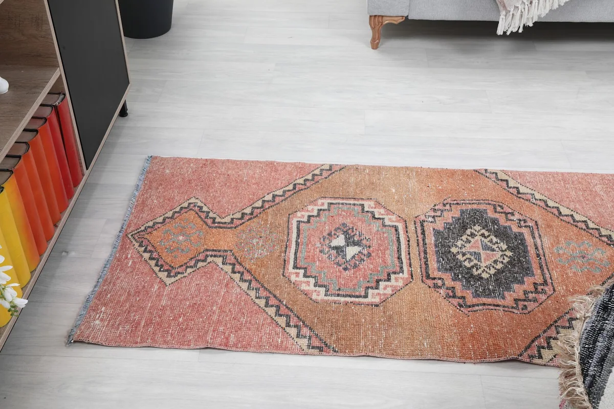 Angled view of the runner rug from one end, showing the series of geometric medallions